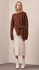 The Amuza Sweater in dark brown. Features chunky knit wrap-style sweater in dark brown alpaca and angora blend. Long sleeves, V-neckline (can be styled backward), self-tie wraps front around the waist, side slits. Pull on. Mid-weight. Oversized silhouette.