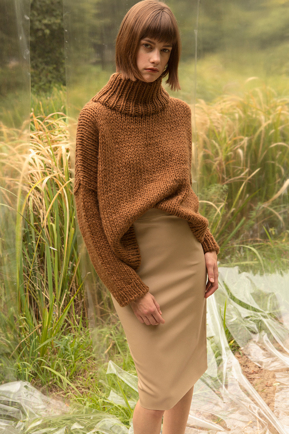 Pullover sweater with chimney collar with dropped shoulders. Gently tapered long sleeves. Slightly cropped. Boxy silhouette. Softy, bulky garter stitch knit. Relaxed fit.