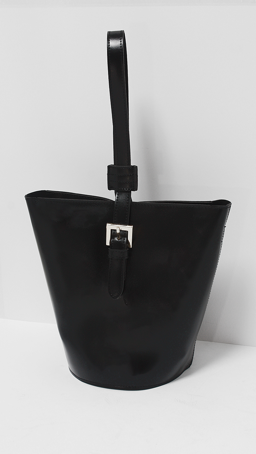 Topas Bucket Bag is a bit more avant-garde. It boasts a slightly geometric shape with a single belt-like strap. Black.