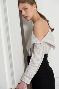 The Agate Top in White-and-Black stripe. Feature one-shoulder design with thin strap, asymmetric draped that sweeps across your décolletage and accentuates the collar. Button down closure along sleeves. 