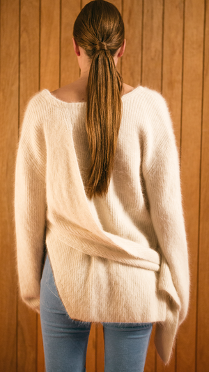 The Amuza Sweater in Ivory. Features chunky knit wrap-style sweater in dark brown alpaca and angora blend. Long sleeves, V-neckline (can be styled backward), self-tie wraps front around the waist, side slits. Pull on. Mid-weight. Oversized silhouette.