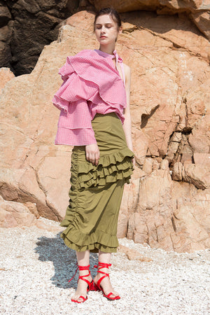 The Aurélie Skirt in Khaki featuring layered ruffles and cut on a bias. Asymmetrical hem. Concelaed side zip closure. Layered ruffles. Partial lined. High rise. 