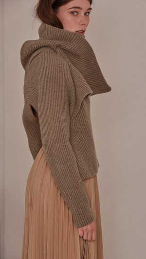 Cecil Sweater, a knit sweater in beige. Rollback collar with pointed wide cowl neck. Drop shoulder design, open rib details. Short length in open back. Designed to be loose fit.