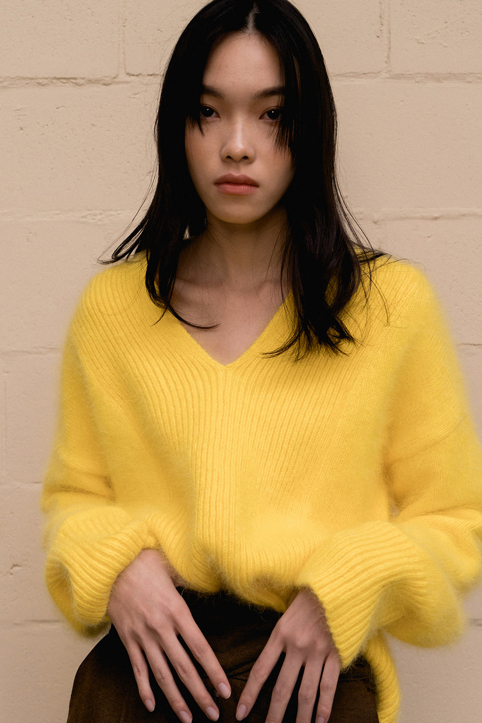The Cecily angora sweater, long sleeved pullover with deep V-neck in yellow lambs wool blend. Dropped shoulder.