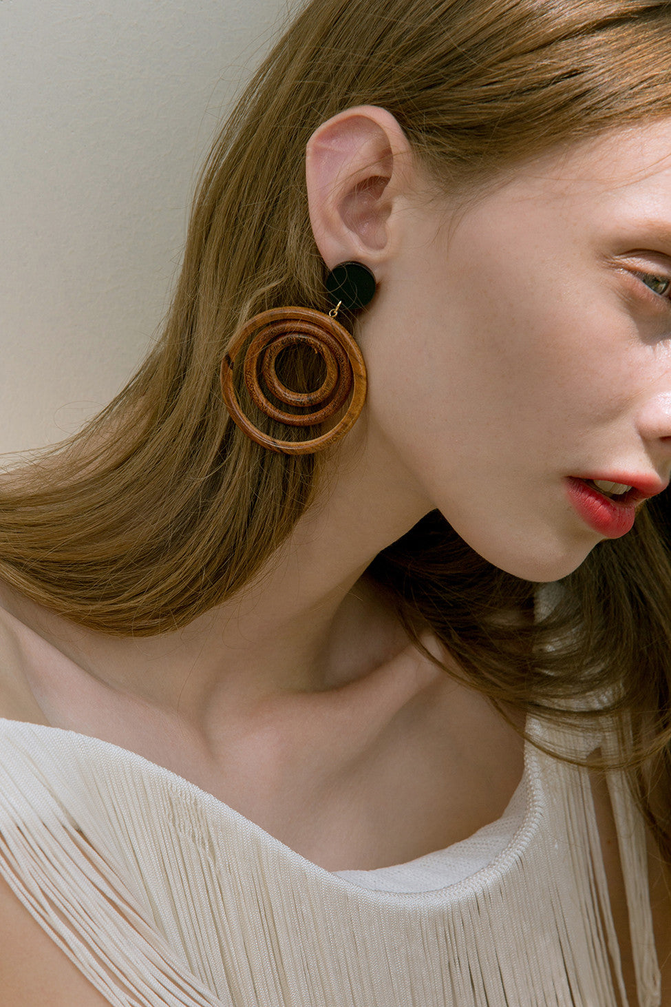 The Cellena, a pair of spiral design earring in wood. Gold metal post back. Sold as a set.