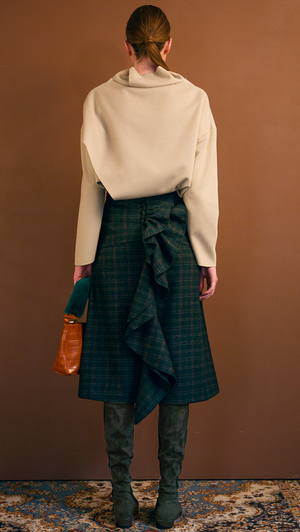 The Charlie Skirt in patterned with green plaid. With a high-waisted polished A-line style with back ruffle details. Over-the-knee length. Concealed zip closure. No pockets.