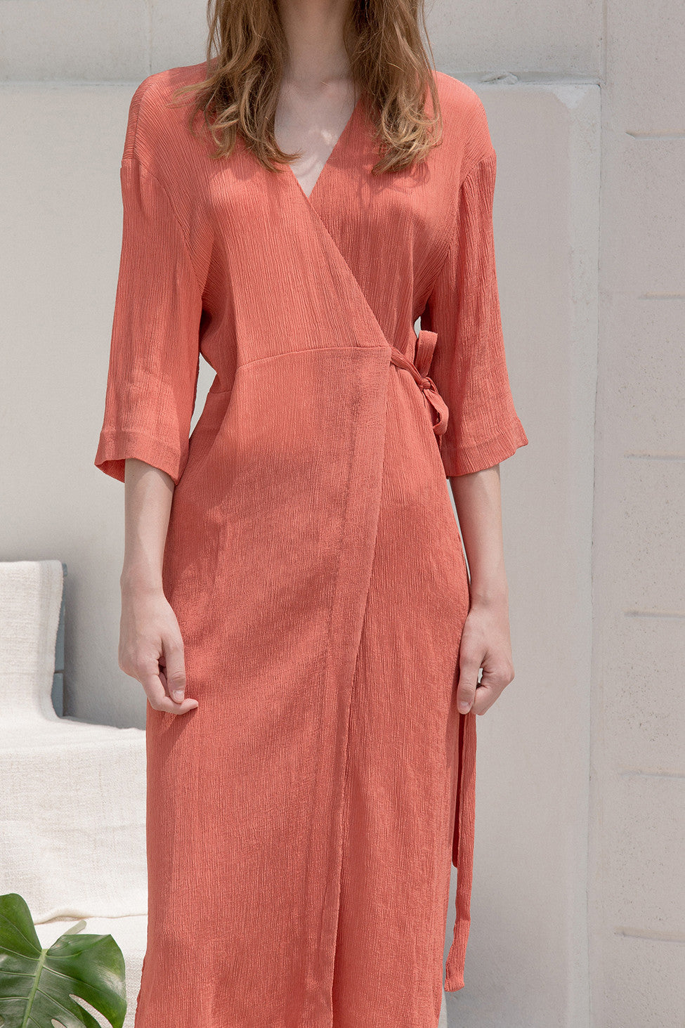 The Corinna pleats dress in wrap front with sash belt, side slits, quarter sleeves. Pull on.