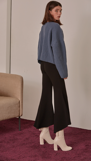 Asymmetric edged peplum leg pant. Centre-front concealed zip fastening along side. No pockets. Slim-fitting at thigh. Gently flare out hem. Designed for high-rise cut. Mid rise with a wide frayed leg.