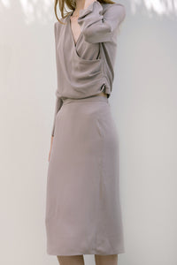 The Emmeline Skirt in French Beige featuring fluted hem and elasticated waistband at back. Side slits. No pockets. Partial lined.
