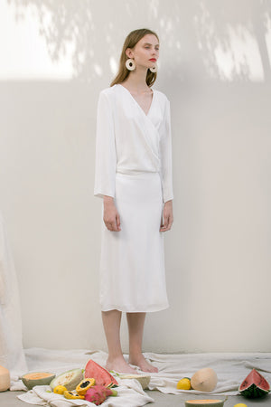 The Emmeline Skirt in White featuring fluted hem and elasticated waistband at back. Side slits. No pockets. Partial lined.