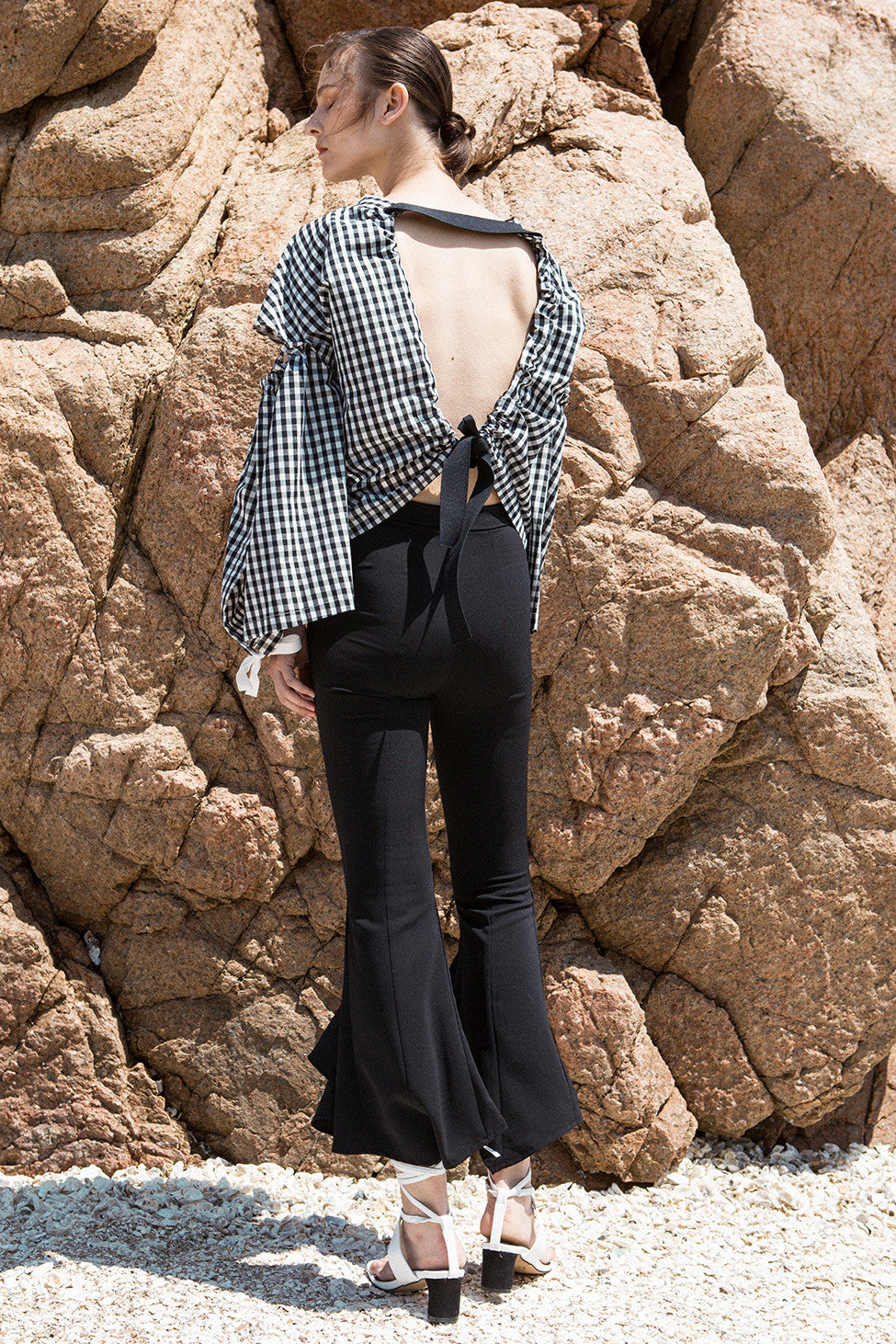The Faroe Pant in Black featuring mid-rise peplum draped ruffle on leg. Centre concealed zip and hook and bar closure. 