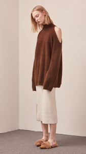 The Fella Sweater in dark brown. Features rolled neckline, long sleeves, drop shoulder, side slits. Pull on. Relaxed silhouette.