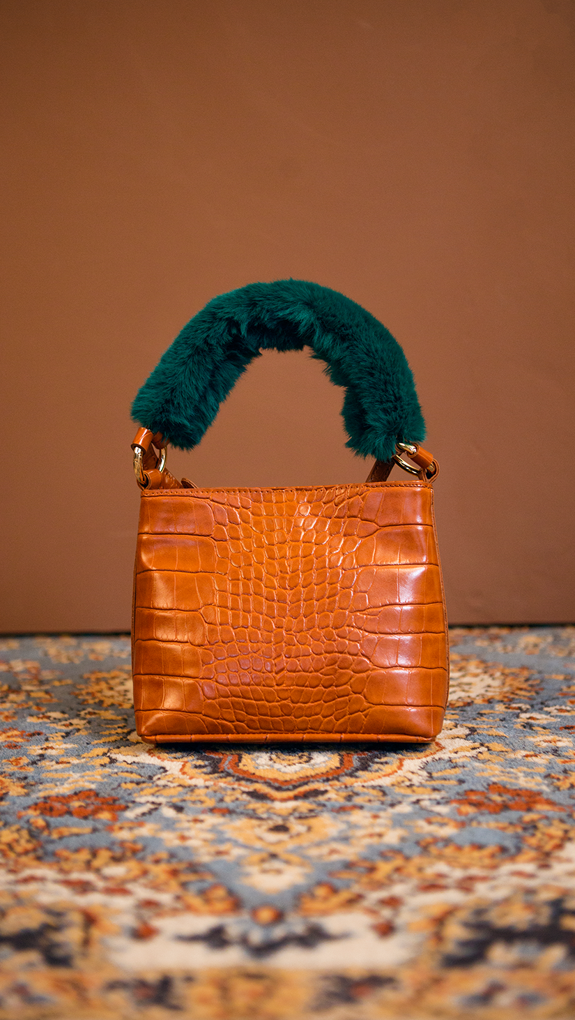 Forziéri bag in brown/deep green. Fur handle, front flap magnetic snap tab closure. Interior pockets. Detachable shoulder straps. Structured bottom.