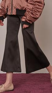 Cropped Gisela pant with flared leg in black. Lustrous black stain feels. Four pocket styling. Zipper fly and tab closure. 