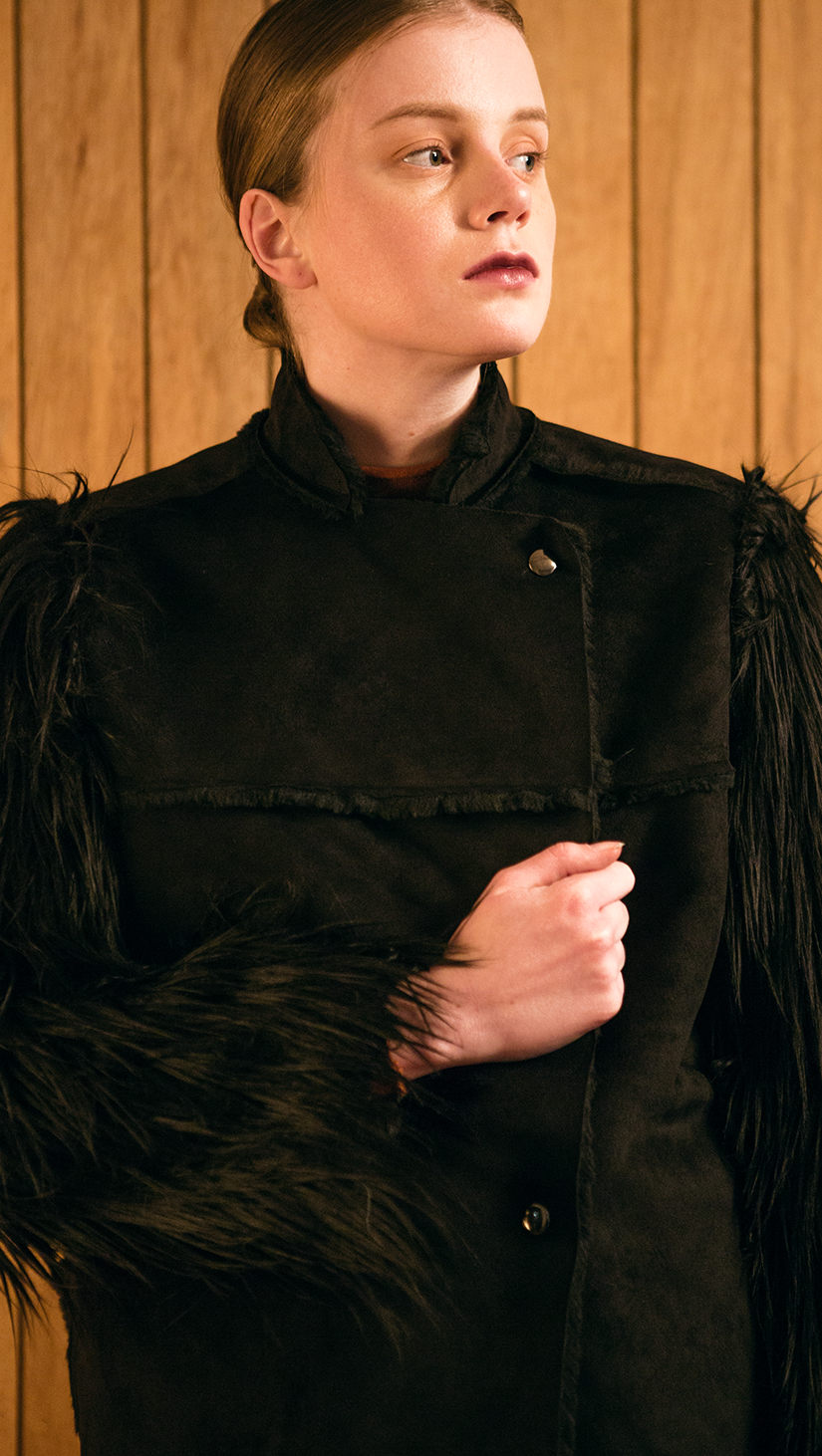 The Hanneli Shearling Jacket in Black. With a dramatic faux-Mongolian fur covered sleeves, front snap button closing, fully shearling lining. Oversized silhouette.  