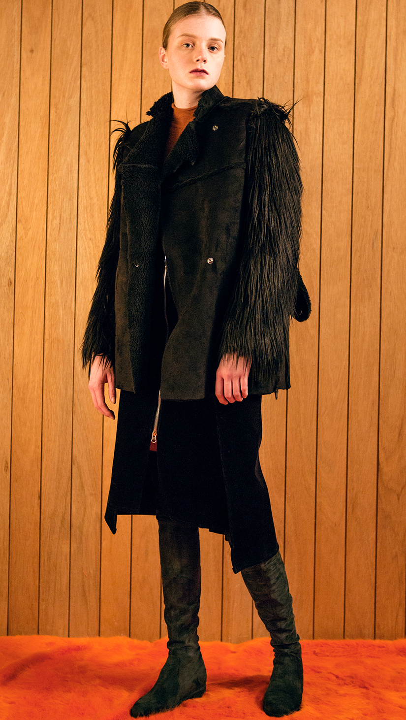 The Hanneli Shearling Jacket in Black. With a dramatic faux-Mongolian fur covered sleeves, front snap button closing, fully shearling lining. Oversized silhouette.  