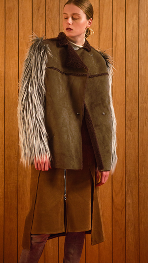 The Hanneli Shearling Jacket in Khaki. With a dramatic faux-Mongolian fur covered sleeves, front snap button closing, fully shearling lining. Oversized silhouette.  