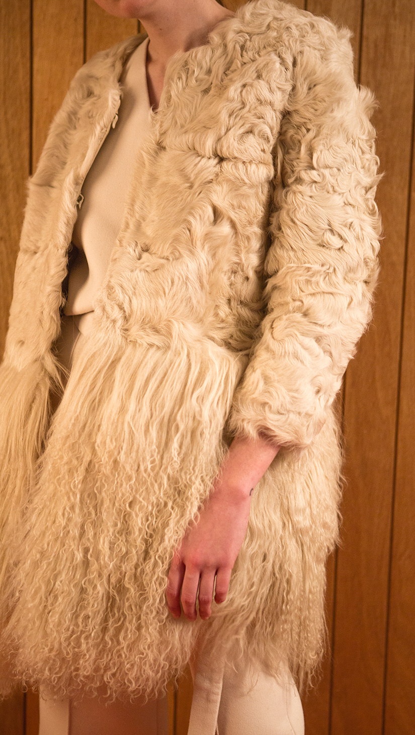 Heavy cream lamb-fur coat in timelessly chic style, fuzzy ivory mongolian-lamb fur hemline. Cropped length in sleeves, collarless, open-style with hook-and-eye closure. Mid-weight. Fully lined. Oversized. Straight cut.