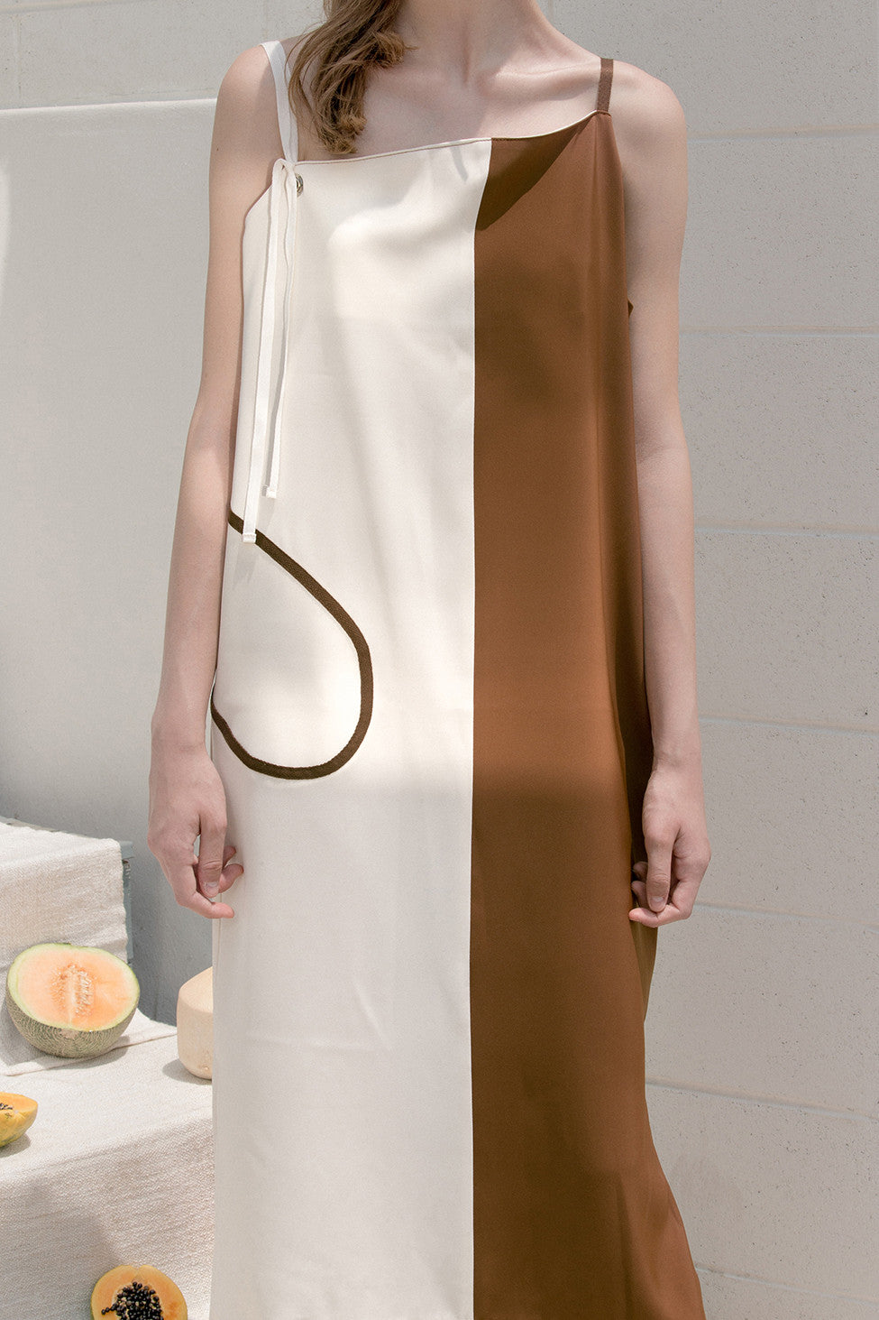 The Hayett dress in asymmetric neckline with thin shoulder strap and side slits. Pull on. 