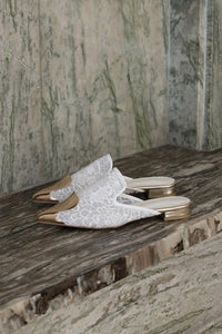 The Helios featuring an almond toe with gold brass detail in White. Lightly padded footbed. 