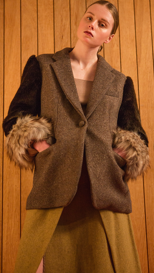 The Holborn Jacket in shearling sleeves in chocolate-brown, caramel-brown fox-fur cuffs, notched collar, dropped shoulder, one button closure at front. Fully lined. Relaxed silhouette.