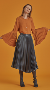 The Janye is a button-down blouse in non-sheer belled sleeves with accordion pleats. With a cowl neckline, slightly loose bodice and extra long sleeves.