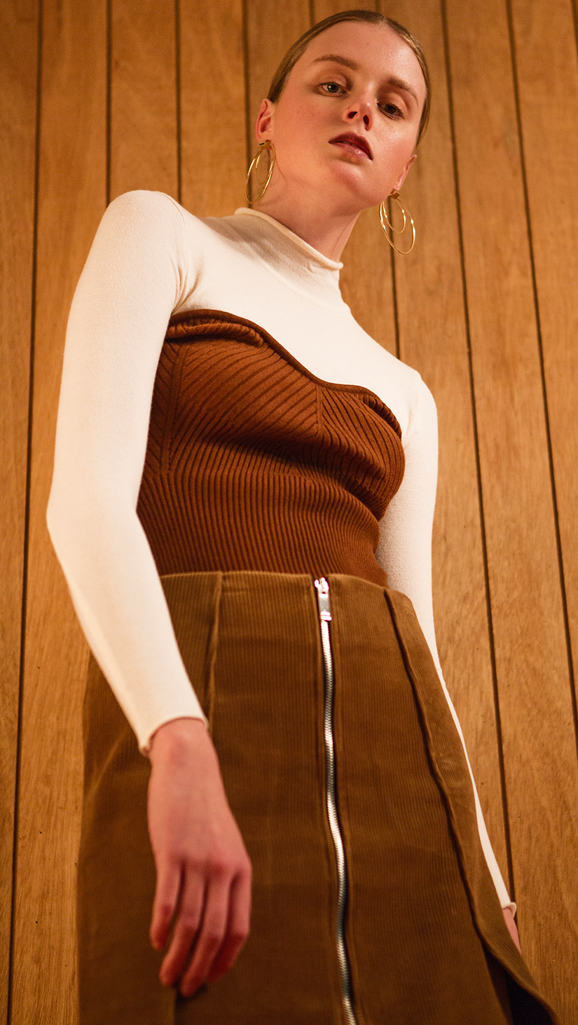 The Kaare Top in Brown/Ivory. With a seamless mock neckline, heart shape bustier layered in lightweight knit top. Designed to be slim fitting. Pulls on.