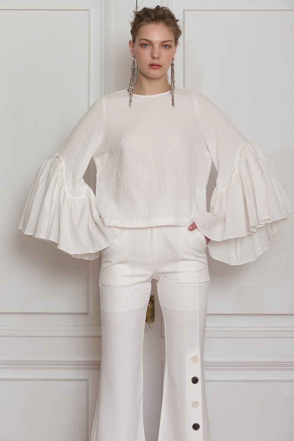 The Kahena Top in White featuring round neckline, gathered ruched bell sleeves with concealed zip closure at back. Dropped shoulder.