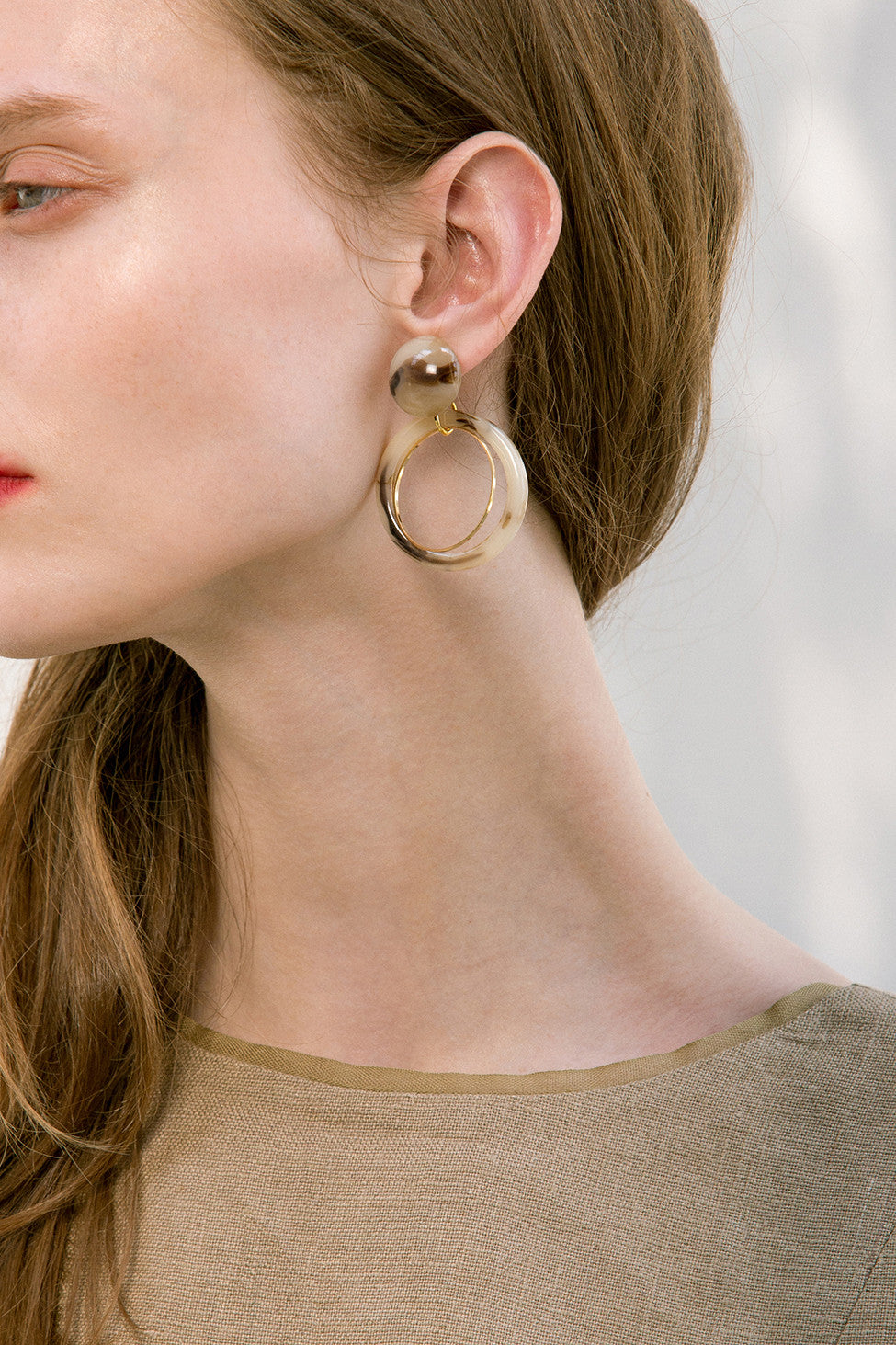 The Koh, a pair of porcelain round drop earrings. Gold metal post back. Sold as a set.