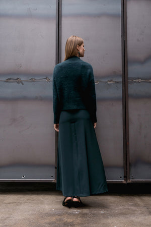 Easy skirt from Kozha in Hunter Green. Concleaed zip fly with hock and eye closure. High rise. Round hem. Unlined. Gently flared silhouette. Floor length.