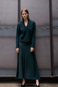 Easy skirt from Kozha in Hunter Green. Concleaed zip fly with hock and eye closure. High rise. Round hem. Unlined. Gently flared silhouette. Floor length.