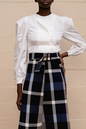 The Larkin top featuring round neckline, gathered button down closure at front, long sleeves with ruched cuffs. Pull on.  