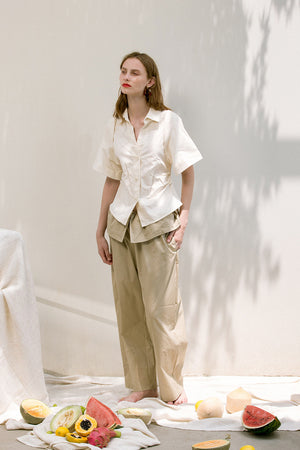 The Lassie Pant in beige featuring elastic waistband, two slant pockets. Lightweight.