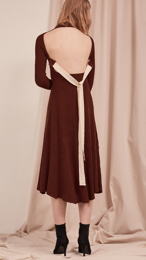 The Leila Dress in Dark Mocha. With ribbed midi dress with cut out back and white cotton tie open back. A-line shape. Slightly loose fit. Mid-weight. Stretchy fabric.