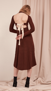 The Leila Dress in Dark Mocha. With ribbed midi dress with cut out back and white cotton tie open back. A-line shape. Slightly loose fit. Mid-weight. Stretchy fabric.