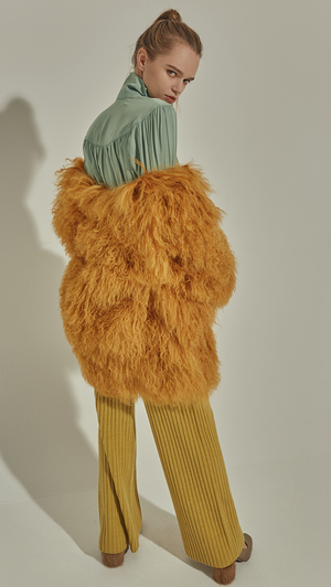 The Lellyn Fur Coat in Mustard. Exaggerated furry long sleeves, hook and eye closure. Oversized fit. Fully lined.