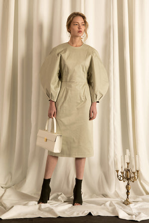 The Leyla dress in Olive, featuring round neckline, long puff sleeves with raglan detail at cuff, concealed zip fastening at the back. Fitted bodice. 