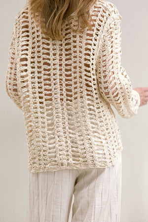 The Loe fishnet knit in Ivory featuring deep V-neckline, long sleeves. Pull on. Comfortable silhouette. 