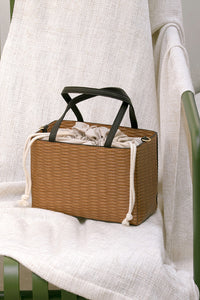Mamba bag in Brown. Woven straw basket bag with fabric insert. Top handles. Detachable shoulder straps. 