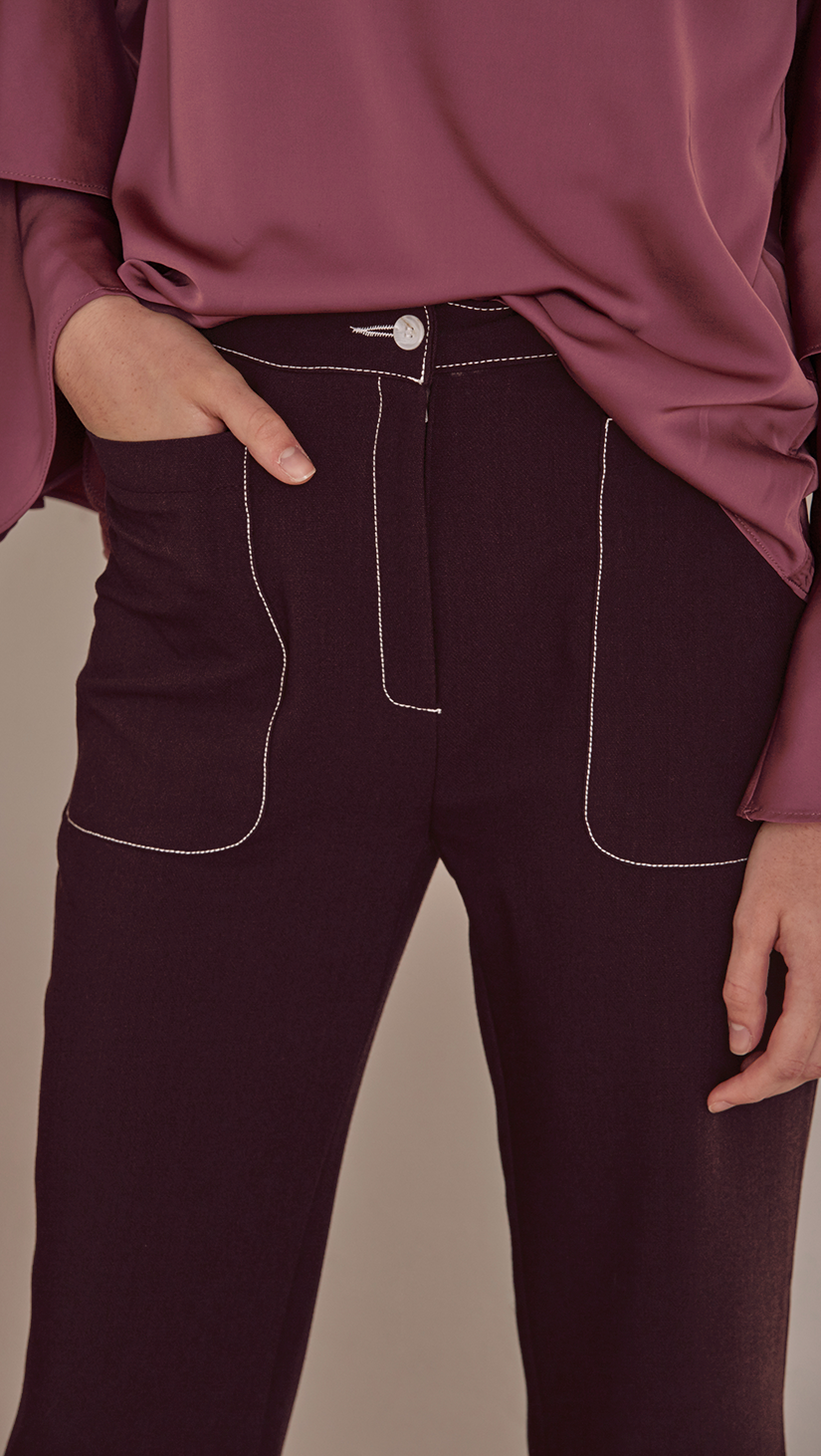 Rocha Pant in Wine. Two front pockets, zipper fly, tap closure. Styling in contrast white stitching. Straight cut, flare out hem. Cut for a slim fit. 
