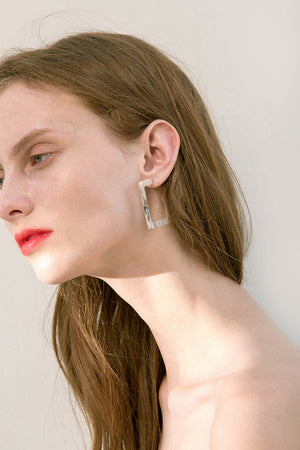 The Merit, a pair of contemporary hoop earrings. Gold metal post back. Sold as a set.