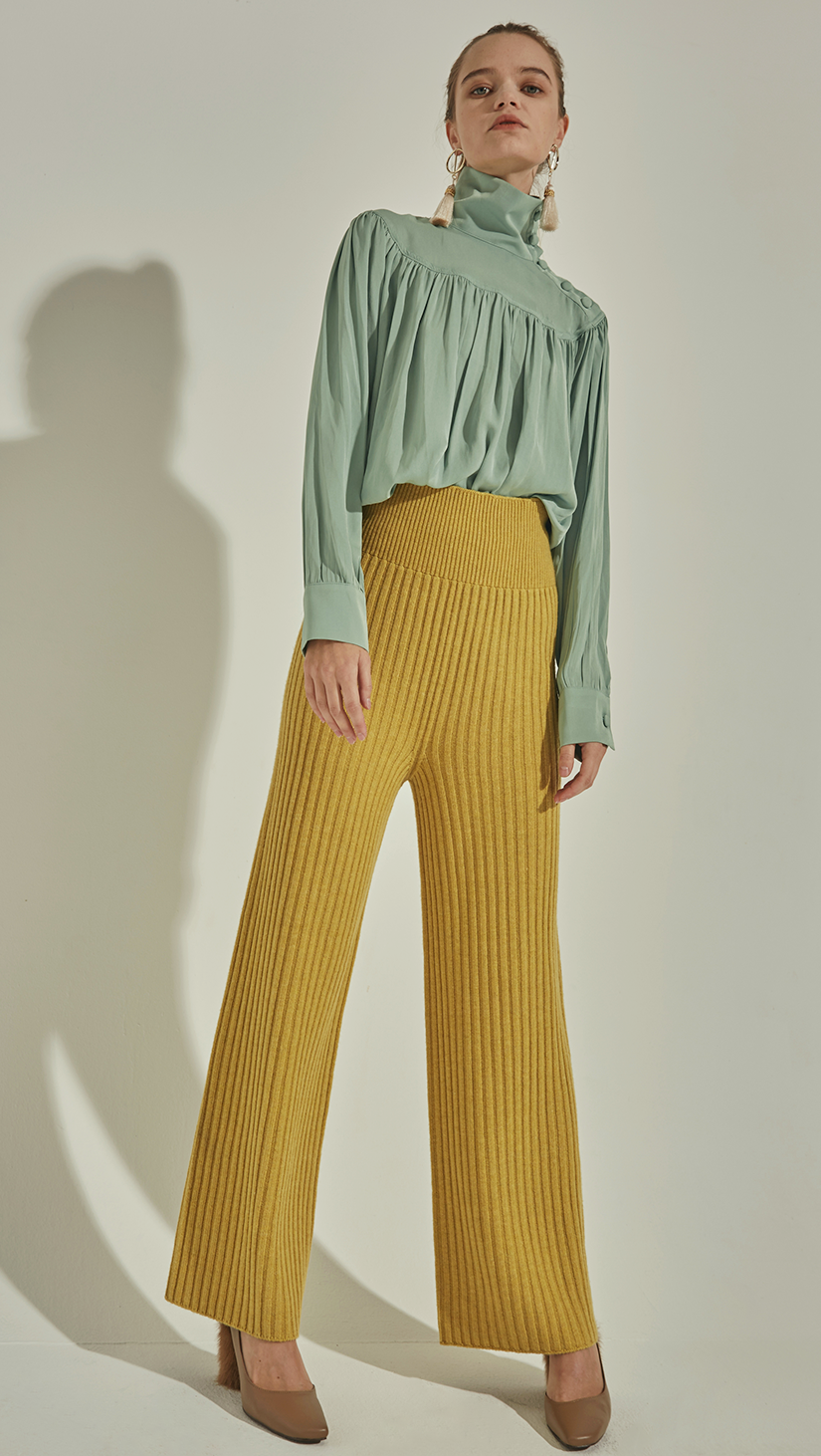 The Mikaela Pant is brick wool trousers sit high on the waist with an elasticated ribbed-knit trim. Wide leg cut. Extra long in length. No pockets. Warm and super soft wool fabric. Relaxed fit. Wholegarment Made.