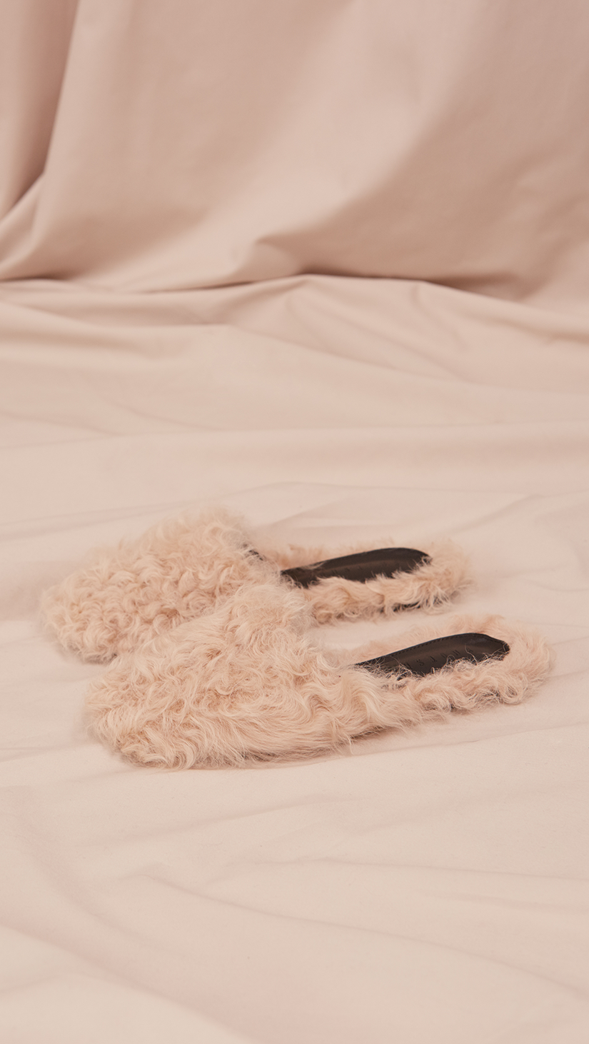 Études Furry Slide in Ivory Shearling. Shearling mule, created entirely with curly lambs wool. Slide loafers with a round square toe, padded leather foot bed and rubber soles. Slip on.  