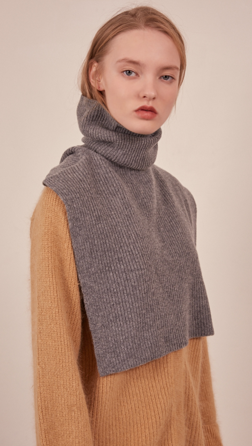 The Muir Turtleneck Knit in grey with no sleeves. Pull on. 