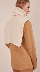The Muir Turtleneck Knit in ivory with no sleeves. Pull on