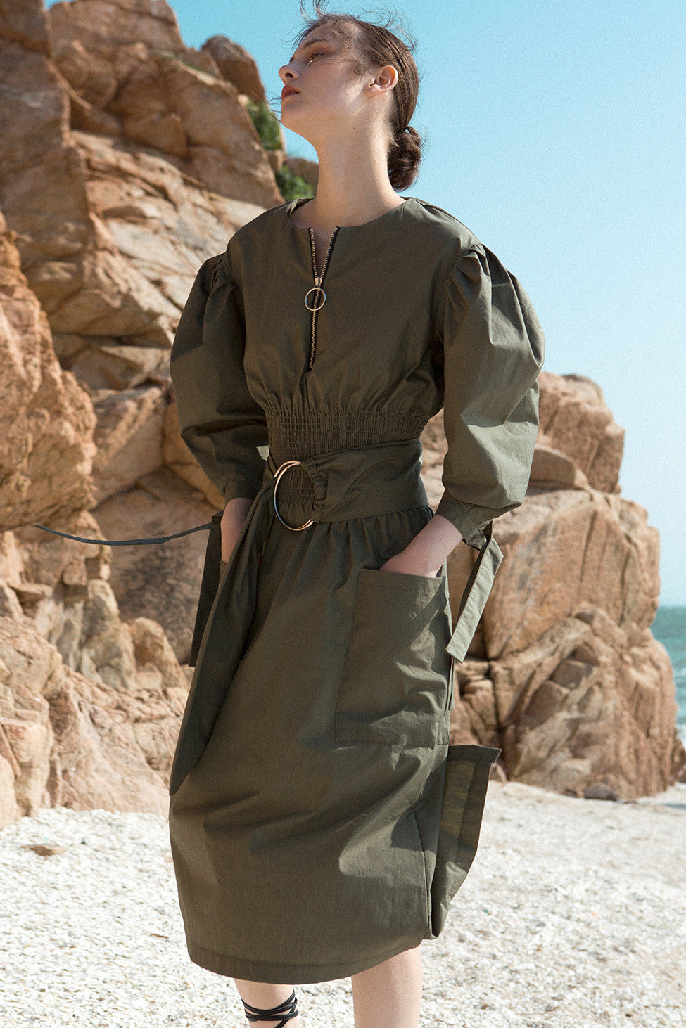 The Myrtle Dress in Khaki featuring scoop neckline, three-quarter ballon sleeves. Corset-inspired gathered elastic waistline with detachable self-tie fastening belt.