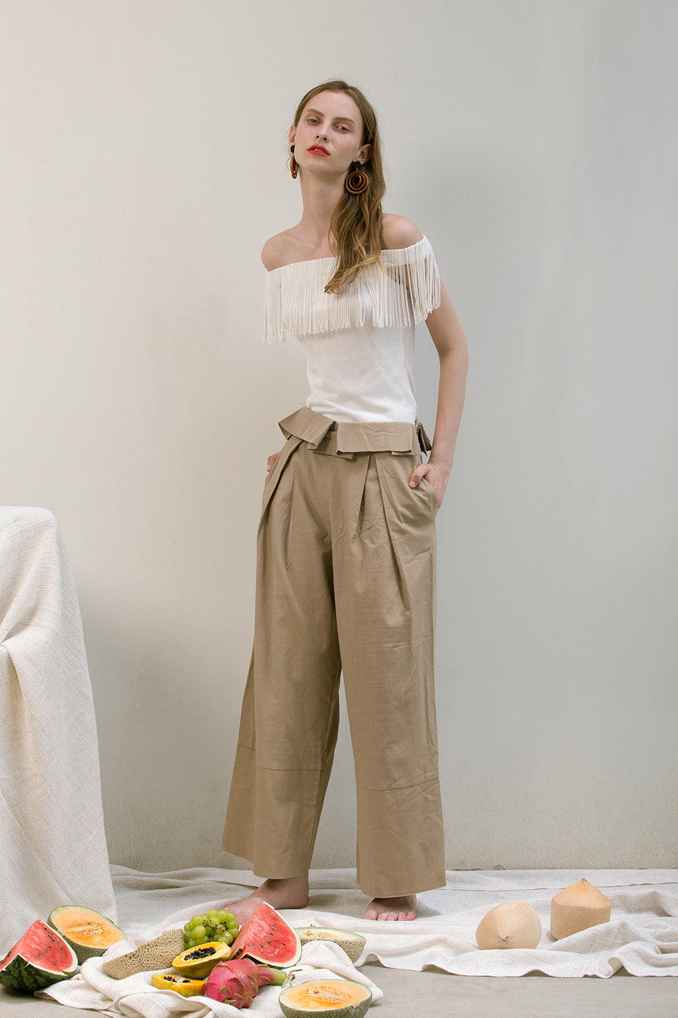 The Noelle Pant in brown featuring pleated front with origami design, two slant pockets. Lightweight.