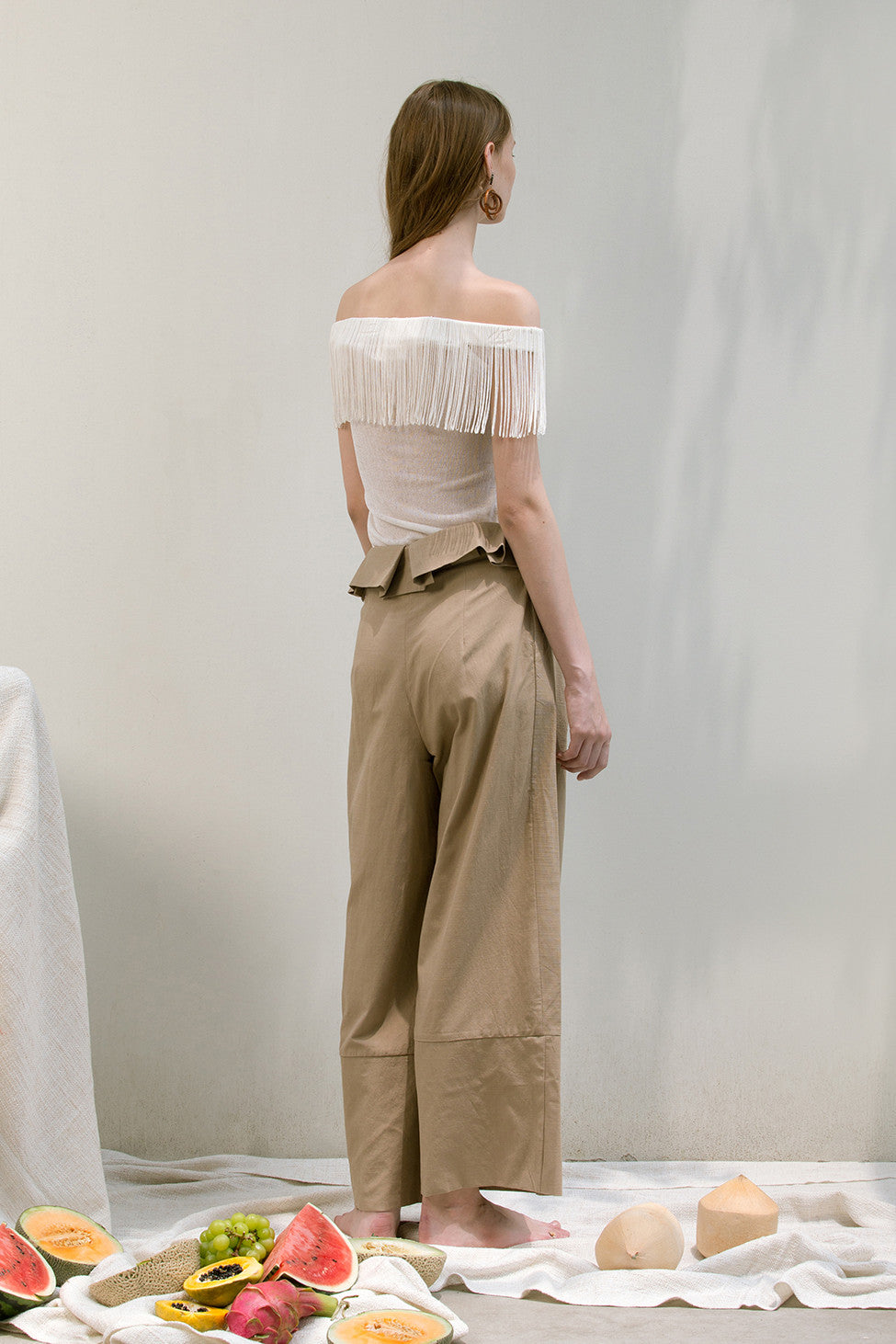 The Noelle Pant in brown featuring pleated front with origami design, two slant pockets. Lightweight.