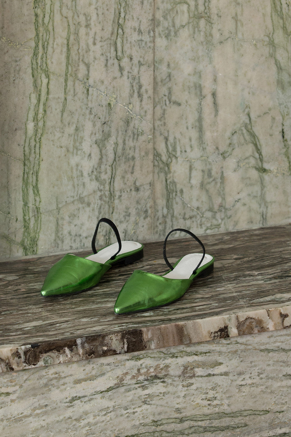 The Pajama sandal in neon metallic green. Almond toe. Thin strap across upper. Slip-on design.