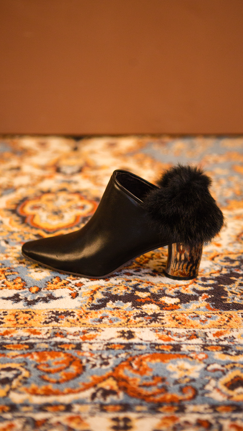 The Ravello Fur Mules in Black. Slide loafers with a pointy toe, padded leather foot bed and rubber soles. Slip on.  